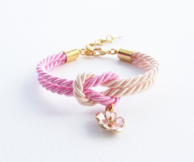 Light pink and ivory cream knot rope bracelet with pink sakura charm - 手链/手环 - 其他材质 粉红色